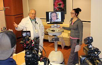 Dr. Raymond Schmoke, Dr. Jayne Lee (on monitor), and Sara Harris, RN, at a media preview of the telemedicine program for inpatients overnight at Dosher's Patient Care Unit.