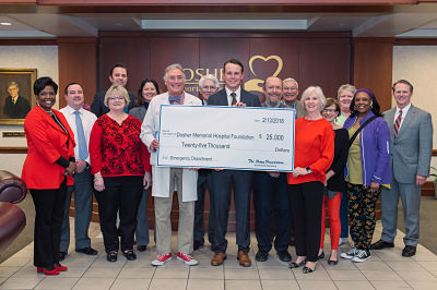 Posing with a $25,000 check from The Orton Foundation are Dosher Foundation President Lynda Stanley, Dosher Foundation Board member Adam Powell, Dosher Board member Debbie Wood, Dosher Foundation Board members Mark Bachara, Beth Nelson, and Dr. Joe Pat Hatem, Dosher Board member Rev. Jim White, Orton Plantation Property Manager Dillon Epp, Dosher Board members Dr. Scott Starks and Robert Howard, Dosher Foundation Board Chair Barbara Boland, Dosher Foundation Board members Joyce John and Libba Motsinger, Dosher Board Member Karen Taylor, and Dosher Memorial Hospital President & CEO Tom Siemers. (Photo by Anne Liles)