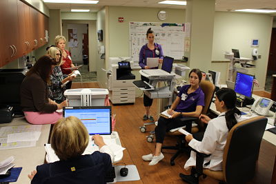 Some of the RN, Pharmacy, Physical Therapy, Patient Care Technician, Case Manager, and Hospitalist staff during morning rounds in the Patient Care Unit.