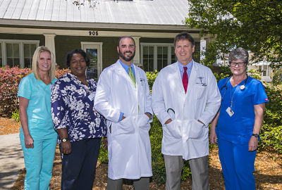 Dr. Alex Newsom (center) poses with colleagues at Dosher Medical-North Howe Street primary care physician practice. For an appointment, call 910-457-5657.