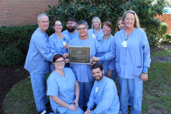 With the latest award for eliminating surgical smoke in our operating rooms are several of the Dosher Surgical Services staff: (front row) Liz M., Eugene C.; (back row) Bert H., Chelsea C., Billy M., Carolina M., Kim Y., Michele G., Kathy P., and Bobbie C.