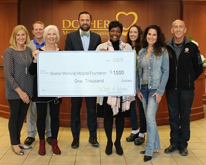 Pictured are (front row) Uncorked by the Sea Owner Meredith Muehleib, Dosher Foundation member Barbara Boland, Dosher Foundation Board Chair Mark Bachara, Dosher Memorial Hospital Foundation President Lynda Stanley, and LaPolena Bed and Breakfast owners Suzanne Foster and Jeff Ellis. (second row) Dosher President and CEO