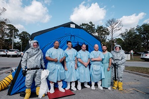 Robert Scharett, RN, of Dosher, pictured far left, and Kelli Harris, RN, of Dosher, pictured far right, participated in the HAZMAT drill along with representatives from Sunny Point Military Terminal.