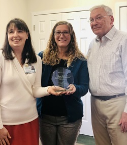 Dr. Leigh Vaughan, Dosher Physician Advisory Board Chair and Family Medical Practitioner at the Dosher Wellness Center, Kate Inman, Dosher’s Practice Network Administrator, and Robert Howard, Chairman of the Dosher Board of Trustees, with the Guardian of Excellence Award.