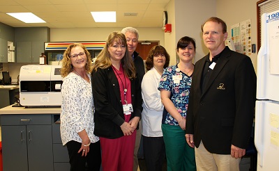Pictured L &#x2013; R in the Dosher Hospital Lab: Dosher CNO, VP, and COO Carol Northup, Lisa Dollar, Lead Phlebotomist, Cardiopulmonary Director John Watkins, Lab Director Mendy Williams, Faith Aquino, AMT, and Dosher President and CEO Tom Siemers.